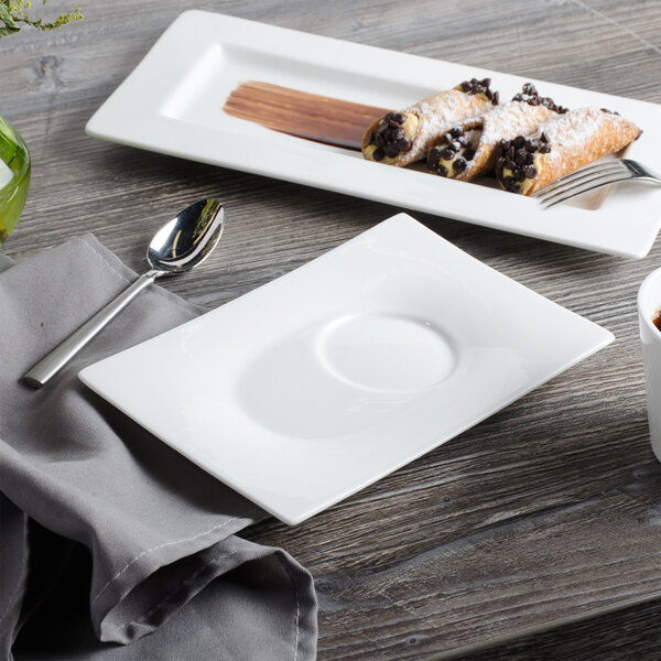 A white square Bon Chef bone china saucer with a spoon on it.