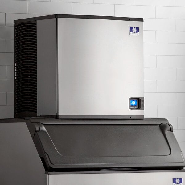 A Manitowoc Indigo NXT air cooled ice machine with a stainless steel top.