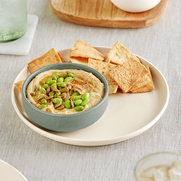 hummus and pita chips on a plate