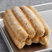 Three Field Roast plant-based Italian sausage links sitting on a tray.